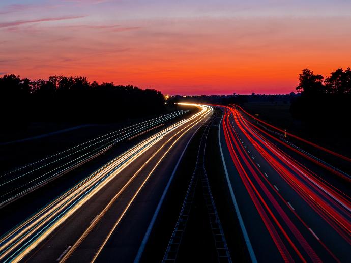 time-lapse photography of road under gray and orange sky